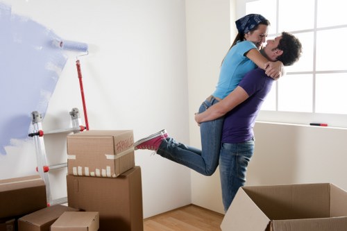 Furniture and boxes being carried through a Bow property