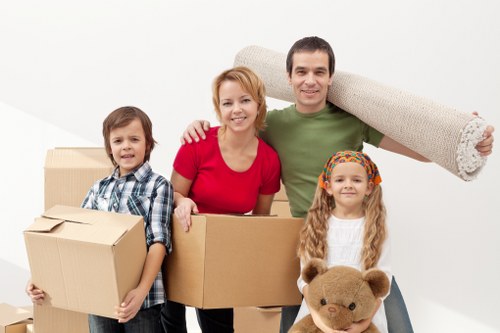 Mover handling furniture carefully during a scheduled removal service