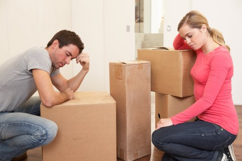 Local office movers handling desks and equipment in an East London workspace