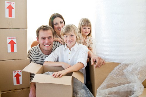 Packed moving boxes and furniture ready for transport in Bow
